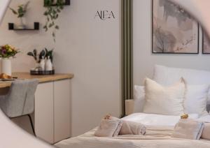 a bedroom with a bed with two pillows on it at ALEA-Apartment - Bad Wildbad in Bad Wildbad