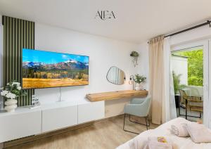 a living room with a tv on a white wall at ALEA-Apartment - Bad Wildbad in Bad Wildbad