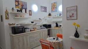 a kitchen with a counter with a table in it at Il Viandante in Catanzaro +15 photos