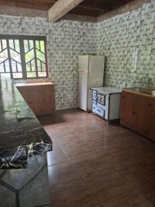 a kitchen with a refrigerator and a counter in it at Siio do bambu in Joinville