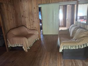 two chairs sitting in a room with wood floors at Siio do bambu in Joinville +10 photos