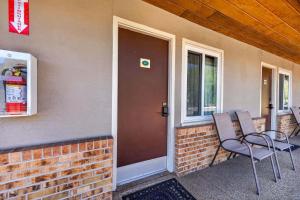 a porch with two chairs next to a door at Eagle Motel Suite 107 in Manitou Springs