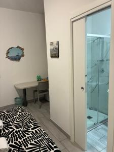 a bedroom with a glass shower and a desk at Cavallerizza home in Naples +34 photos