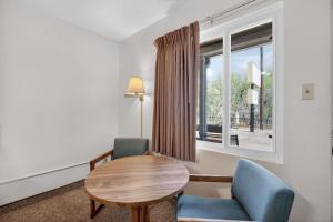 a room with a table and two chairs and a window at Eagle Motel Suite 108 in Manitou Springs +10 photos