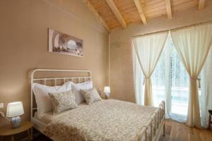 a bedroom with a bed and a large window at Villa Stonica in Kringa +25 photos
