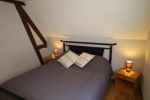 a bedroom with a bed with two lamps on tables at S'Kamèrlè in Hatten