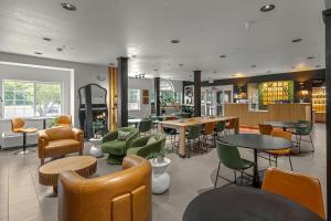 a lobby with tables and chairs and a library at The Block Hotel Bentonville in Bentonville