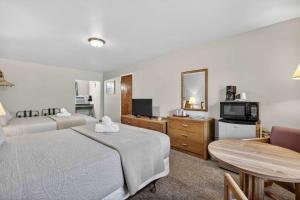a hotel room with two beds and a television at Eagle Motel Suite 110 in Manitou Springs
