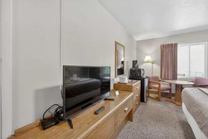a living room with a large flat screen tv at Eagle Motel Suite 110 in Manitou Springs
