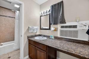 a bathroom with a sink and a microwave at Eagle Motel Suite 110 in Manitou Springs +10 photos