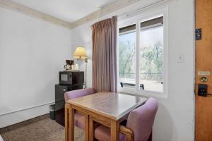 a dining room with a table and chairs and a window at Eagle Motel Suite 112 in Manitou Springs