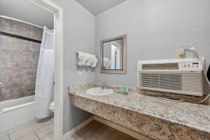 a bathroom with a sink and a microwave at Eagle Motel Suite 112 in Manitou Springs +9 photos