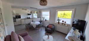 a living room with a couch and a table at Ferienwohnung -Diemelaue- in Warburg +23 photos