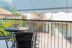 a table and chairs on a balcony with an umbrella at Cilento Reset in Sapri