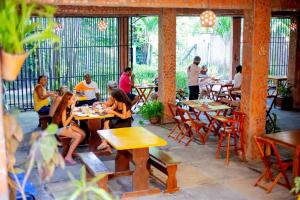 a group of people sitting at tables in a restaurant at Pousada São José in Barreirinhas