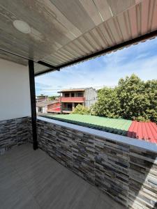 a view from the balcony of a building with a brick wall at Hotel Sol del Magdalena in La Dorada
