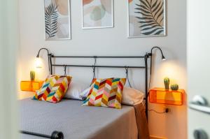 a bedroom with a bed with two colorful pillows at Cilento Reset in Sapri