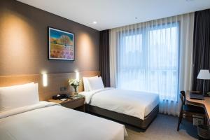 Säng eller sängar i ett rum på IBC Hotel Dongdaemun