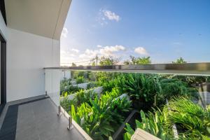 an open balcony with a view of plants at U Villas - Tropical Views Luxury Stay with Pool & Workspace in Ungasan