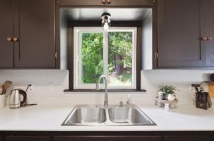 a kitchen counter with a sink and a window at Harmony Hideaway Hammocks Creek Sounds in Shaver Lake +63 photos