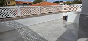 a balcony with a white fence and a tile floor at Q Home San Teodoro Centro in San Teodoro