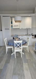 a kitchen with a table and chairs in a kitchen at Q Home San Teodoro Centro in San Teodoro +18 photos
