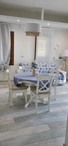 a room with a table and chairs and a bed at Q Home San Teodoro Centro in San Teodoro