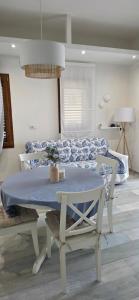 a table and chairs in a room with a bed at Q Home San Teodoro Centro in San Teodoro