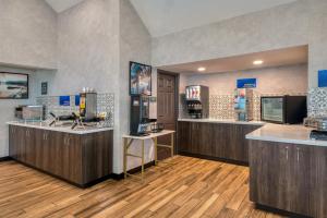 a large room with a kitchen with wooden floors at Best Western Fishkill Inn & Suites in Fishkill