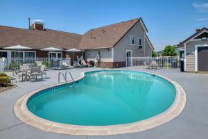 a swimming pool in a yard with a house at Best Western Fishkill Inn & Suites in Fishkill