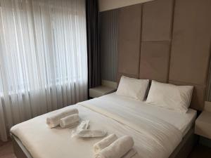 a bedroom with a bed with towels on it at Viva Nova Suit Hotel in Bakanlıklar