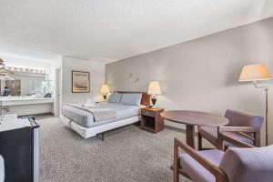 a bedroom with a bed and a table at Eagle Motel Suite 226 in Manitou Springs