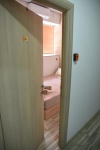 an open door to a room with a bed at Apartment Friends in Veles +41 photos