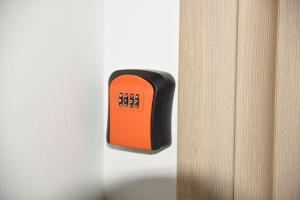 an orange and black object is attached to a wall at Apartment Friends in Veles