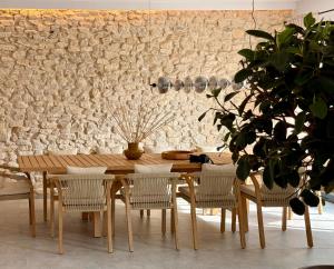 a dining room with a wooden table and chairs at BOGORIA Apartments in Uniejow
