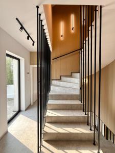 a staircase in a house with black railings at BOGORIA Apartments in Uniejow