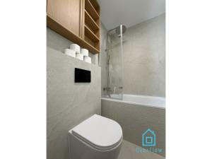 a bathroom with a toilet and a bath tub at Harbor Room at City Center Gdynia & Seaside in Gdynia