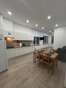 a kitchen and living room with a table and chairs at Fátima Serenity Apartments in Fátima