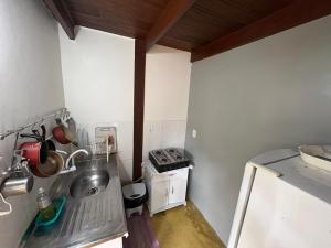 a small kitchen with a sink and a stove at Mi casa Su casa Lofts - LOFT 5 in Angra dos Reis +6 photos