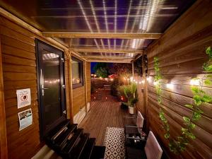 a wooden walkway with benches and plants on a building at Romantic Tiny House with Private Jacuzzi and Garden between Amsterdam Haarlem and Schiphol Airport in Vijfhuizen