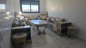 a living room with a couch and a table at Dar D'Asilah in Asilah