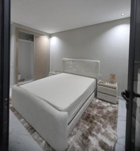 a bedroom with a large white bed in a room at Dar D'Asilah in Asilah
