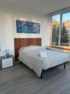 a bedroom with a bed and a large window at Fátima Serenity Apartments in Fátima