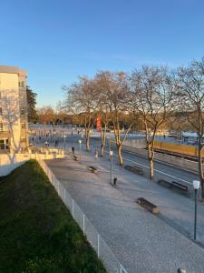 a park with benches and trees and a train at Fátima Serenity Apartments in Fátima