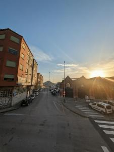 an empty street with cars parked in a parking lot at Alojamiento La Ballena in Santoña +25 photos