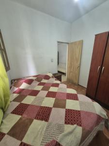 a bedroom with a checkered quilt on a bed at Parque de la Juventud in La Rioja