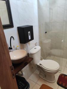 a bathroom with a toilet and a sink and a shower at Hostel Leda Beach in Canoa Quebrada +13 photos