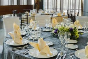 a long table with white plates and napkins on it at Barceló México Santa Fe in Mexico City +27 photos