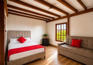 a bedroom with a bed and a couch at Finca Hotel Estrella del Eden in Armenia