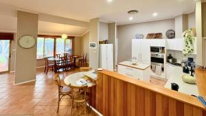 a kitchen and living room with a table and chairs at Coastal Haven on Sandpiper in Broadwater